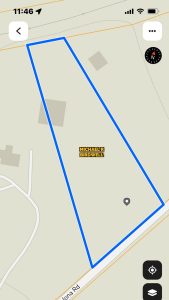 A digital map displays a large, irregularly-shaped plot outlined in blue with "MICHAEL R BIRDWELL" labeled inside, near FM 1187 in Aledo, 76008. Roads and building outlines appear nearby, along with time, signal, and compass indicators.