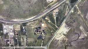 Aerial view of a rural area near Aledo, 76008, showing intersecting roads including FM 1187, open fields, scattered buildings, a pond, and patches of trees. A major highway runs diagonally across the top of the image.