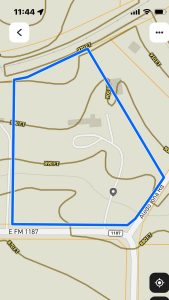 A digital map shows a blue-outlined property in Aledo, TX, bordered by roads including 2301 FM 1187 and Aledo Dana Road. Elevation lines and distances (e.g., 890 FT, 900 FT) are marked. The time on the screen reads 11:44.