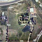 Aerial view of a fenced rural property in Aledo, TX, at 2301 FM 1187, featuring a central house, surrounding trees, pond, driveways, outbuildings, and open grassy areas. Distance measurements are marked along the fence.