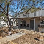 A house with a tree in front of it.